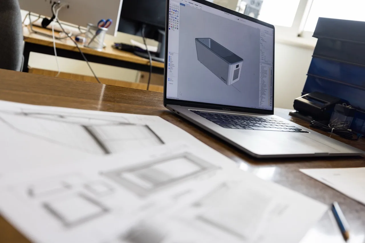 Rocean bath 3D design on laptop with technical drawings in workshop
